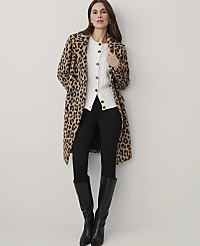 A woman wearing a leopard-print coat, white cardigan, black pants, and black boots stands against a plain white background. carousel Product Image 3