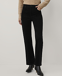 A person wearing a tan knit sweater, black corduroy trousers, and black pointed-toe boots stands against a plain white background. carousel Product Image 2