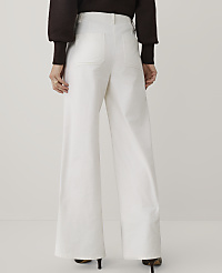 A person wearing a dark brown sweater and wide-leg white trousers stands against a plain light gray background. carousel Product Image 3