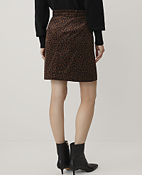 A person wearing a black sweater, a leopard-print skirt, and black ankle boots stands against a plain white background. carousel Product Image 3