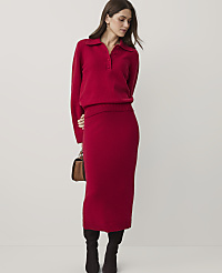 A woman wearing a red knit polo shirt and matching midi skirt stands against a plain white background. carousel Product Image 1