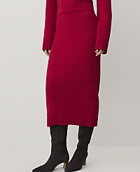 A person wearing a red knit skirt and black boots stands against a plain, light-colored background. carousel Product Image 2