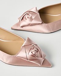 Two pink satin pointed-toe flats with rose accents sit on a plain white background. carousel Product Image 2