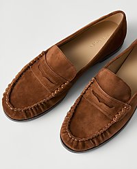 A pair of brown suede loafers rests on a plain white background. carousel Product Image 2