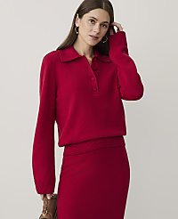 A woman wearing a red knit sweater and matching skirt stands against a plain, light-colored background. carousel Product Image 1