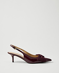 A single burgundy patent leather slingback heel with a bow sits against a plain, light grey background. carousel Product Image 1