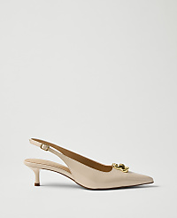 A single beige patent leather slingback heel with a gold buckle sits in the foreground against a plain, light grey background. carousel Product Image 1