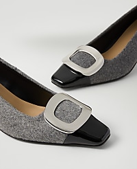 A pair of grey felt pumps with black patent leather toes and silver buckles rest on a plain white surface. carousel Product Image 2