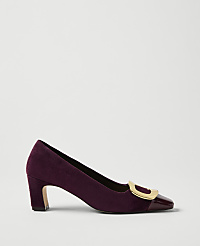 A purple velvet pump with a gold buckle and patent leather toe sits against a plain light gray background. carousel Product Image 1