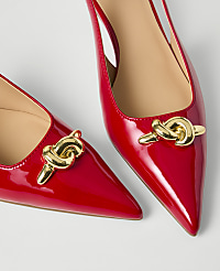 Two red patent leather pointed-toe slingback heels with gold chain ornaments rest on a plain white background. carousel Product Image 2