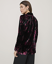 A woman wearing a black and purple floral velvet blazer and black trousers stands against a plain light gray background. carousel Product Image 2