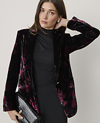 A woman wearing a floral velvet blazer and black clothing poses against a plain, light-colored background. carousel Product Image 3