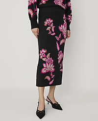 A person wears a black floral knit skirt and matching top with black pointed-toe heels against a plain white background. carousel Product Image 2