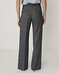 A person wears grey plaid wide-leg trousers and a silver top against a plain, light-colored background. carousel Product Image 4