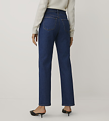 A person wearing a white sweater, blue jeans, and black mules stands against a plain white background. carousel Product Image 3