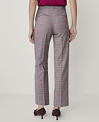 A person stands facing away from the camera wearing a magenta top, plaid trousers, and dark purple heels against a plain light gray background. carousel Product Image 2