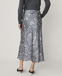 A person wearing a grey sweater and a grey paisley-patterned midi skirt with black heels stands against a plain, light-colored background. carousel Product Image 3