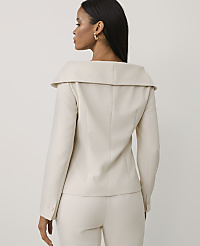A woman wearing a cream-colored blazer and matching trousers stands with her back to the viewer against a plain, light-colored background. carousel Product Image 2