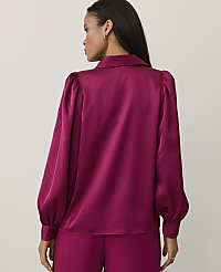 A woman wearing a magenta satin blouse and matching trousers stands with her back to the camera against a plain light gray background. carousel Product Image 2
