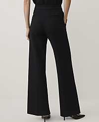 A person wearing wide-leg black trousers and black heels stands against a plain, light-colored background. carousel Product Image 3