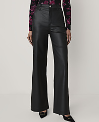 A person wears black faux-leather wide-leg trousers and a floral top against a plain white background. carousel Product Image 2