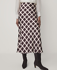 A person wears a white blouse, a burgundy and white plaid midi skirt, and dark brown boots against a plain white background. carousel Product Image 2