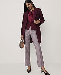 A woman wearing a burgundy coat and plaid trousers stands against a plain light grey background. carousel Product Image 4