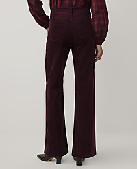 A person wearing a red plaid shirt and burgundy corduroy flare pants stands against a plain white background. carousel Product Image 3