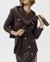 A woman wearing a dark brown ribbed cardigan and leather skirt holds a matching sweater against a plain white background. carousel Product Image 3