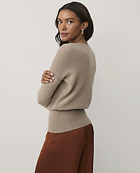 A woman wearing a beige sweater and brown satin skirt stands against a plain white background. carousel Product Image 2