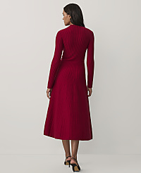 A woman wearing a long-sleeved, ribbed red midi dress and black heels stands with her back to the camera against a plain white background. carousel Product Image 2