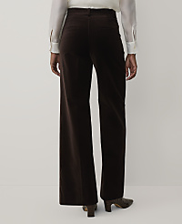 A person wearing a white blouse and dark brown velvet wide-leg trousers stands against a plain light gray background. carousel Product Image 3