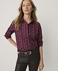 A woman wearing a patterned maroon button-down shirt and dark brown leather pants stands against a plain white background. carousel Product Image 1