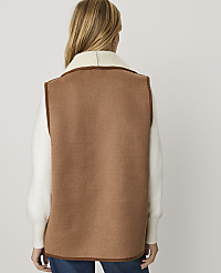 A woman viewed from behind wears a brown vest over a white sweater against a plain light gray background. carousel Product Image 2