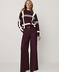 A woman wearing a maroon and white striped sweater and matching wide-leg trousers stands against a plain white background. carousel Product Image 1