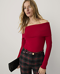 A woman wearing a red off-the-shoulder top and plaid trousers stands against a plain white background. carousel Product Image 1