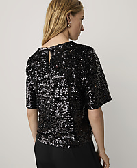 A woman wearing a black sequined top and black trousers stands against a plain white background. carousel Product Image 2