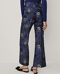 A person wears navy blue floral patterned trousers and black bow-accented sandals against a plain white background. carousel Product Image 3