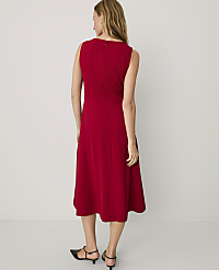 A woman wearing a sleeveless red midi dress and black heels stands with her back to the camera against a plain white background. carousel Product Image 2