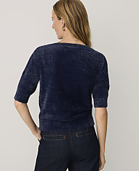 A woman wearing a fuzzy navy blue sweater and dark jeans stands with her back to the camera against a plain light gray background. carousel Product Image 2
