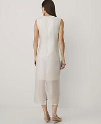 A woman stands with her back to the camera wearing a sleeveless white midi dress against a plain white background. carousel Product Image 2