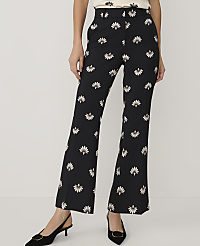 A person wears black floral-print trousers and black pointed-toe heels against a plain white background. carousel Product Image 2