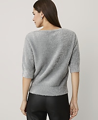 A woman wearing a grey fuzzy sweater and black leather pants stands with her back to the camera against a plain light grey background. carousel Product Image 2