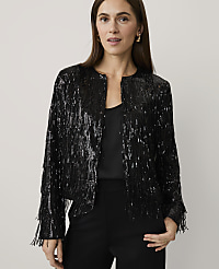 A woman wearing a black sequined fringe jacket and black trousers stands against a plain, light-colored background. carousel Product Image 1