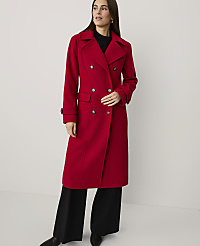 A woman wearing a long red double-breasted coat and black wide-leg trousers stands against a plain white background. carousel Product Image 1