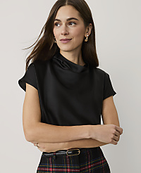A woman wearing a black satin top and plaid trousers stands against a plain, light-colored background. carousel Product Image 1
