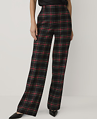 A person wears black, red, and yellow plaid wide-leg trousers and black pointed shoes against a plain white background. carousel Product Image 2