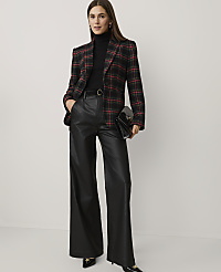 A woman wearing a red and black plaid blazer, black turtleneck, and wide-leg leather trousers stands against a plain white background. carousel Product Image 3