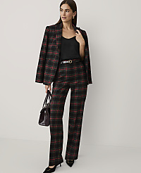 A woman wearing a red and black plaid suit with a black top and heels stands against a plain, light-colored background. carousel Product Image 4