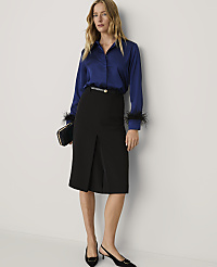 A woman wearing a royal blue blouse and a black pencil skirt stands against a plain white wall. carousel Product Image 3